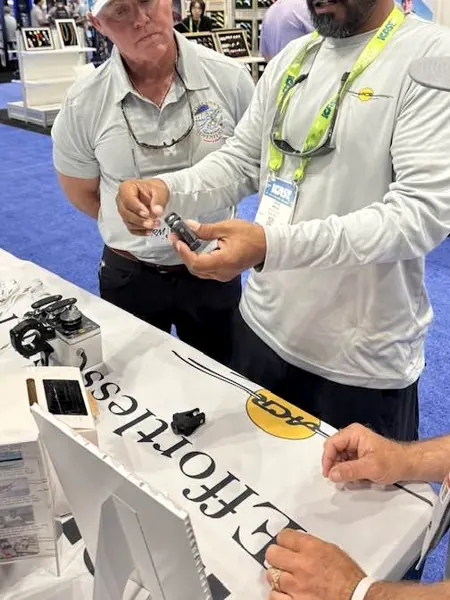 A Bravo ACR team member demonstrating a unit to a visitor at ICAST 2025