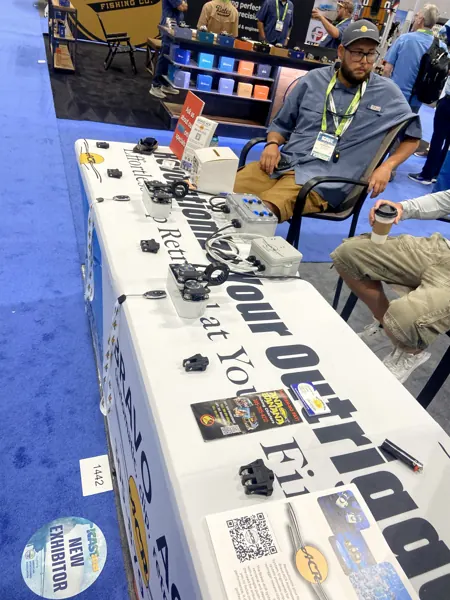 Bravo ACR units laid out on the booth table at ICAST 2025, with a New Exhibitor badge